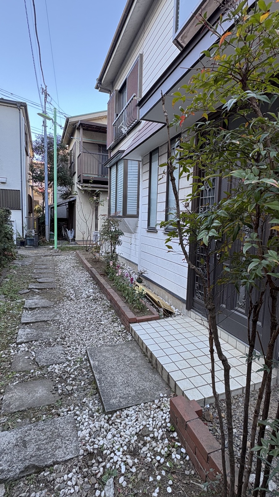 Restored akiya exterior with clean pathway and landscaping in Setagaya Tokyo