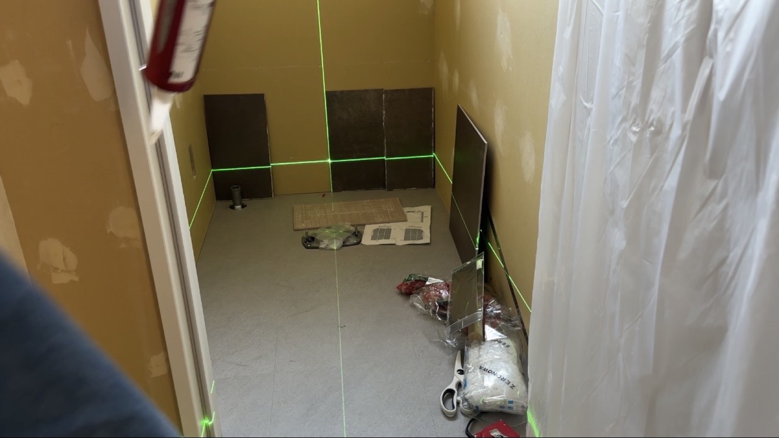 Bathroom tile layout with laser level during akiya renovation