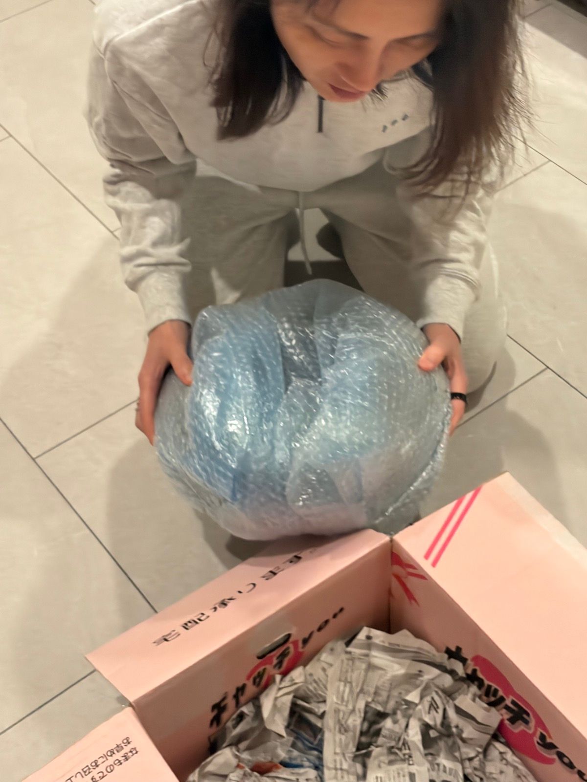 Carefully unwrapping — the moment before you see what you actually bought